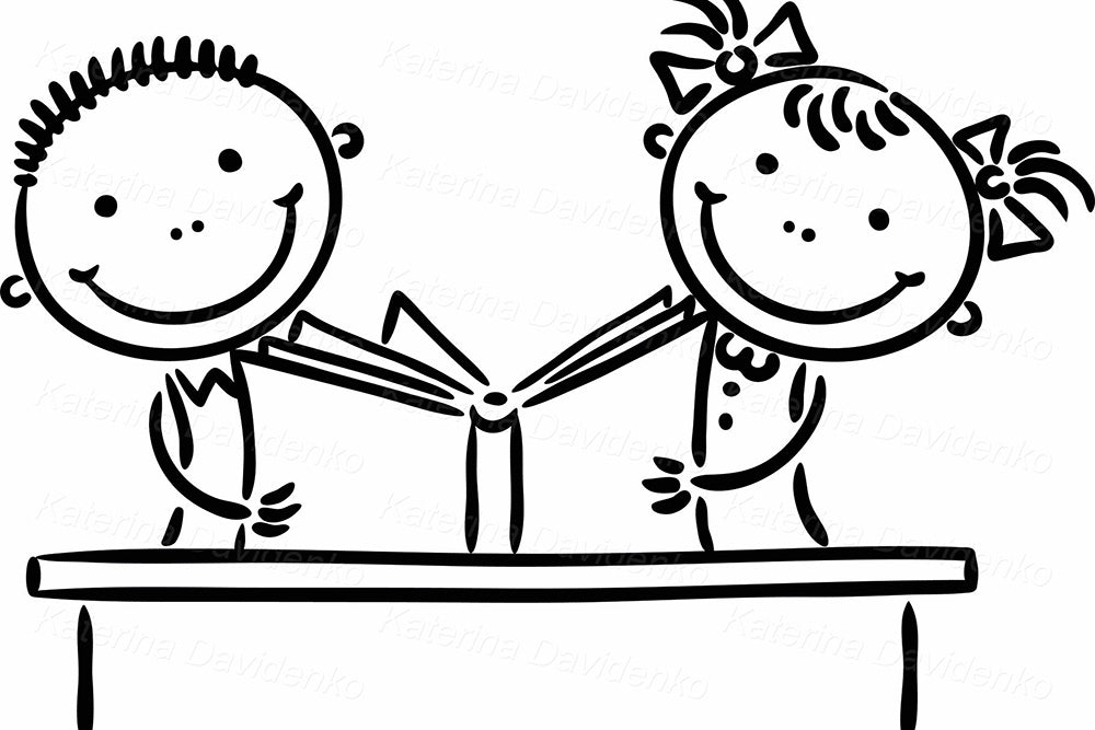 Happy school children at the table reading a book